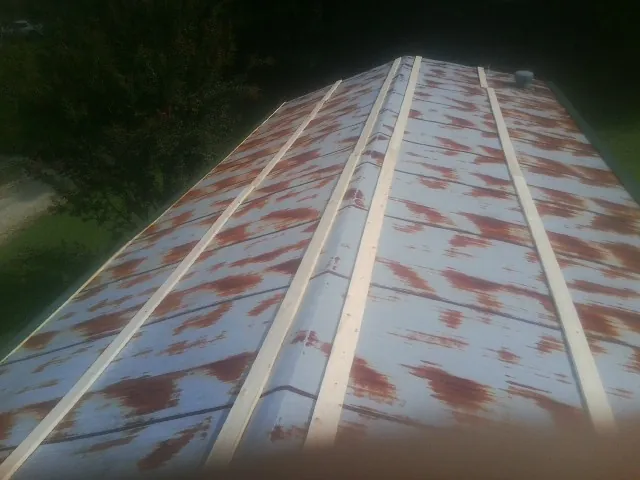 Rusted metal roof panels with new wood purlins before replacement — Storm Damage Roof Repair in Carmel by Roofing Brothers